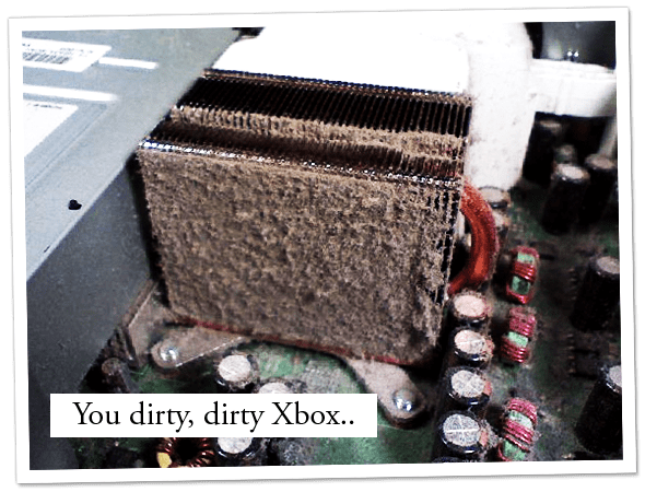 Close up of the inside of a dirty, dusty Xbox.
