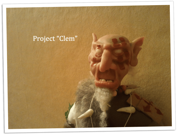 Close up of the partially painted face of the goblin doll.
