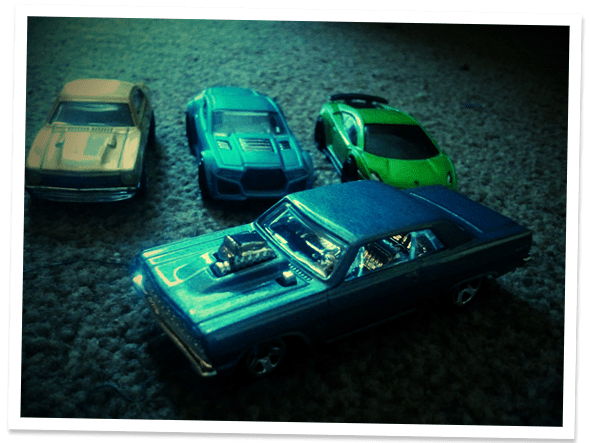 Four small diecast metal cars.