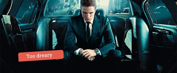 Robert Pattinson as Eric, sitting in his state-of-the-art luxury stretch limousine office.