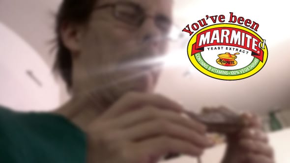 Carlos making a face of disgust as he tries Marmite for the first time.