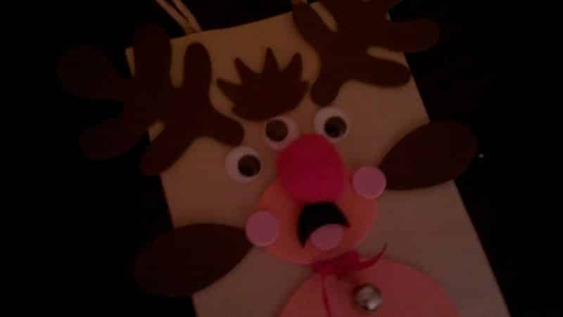 Home-made felt Christmas card featuring Rudolph the red-nosed reindeer, except he has three eyes.