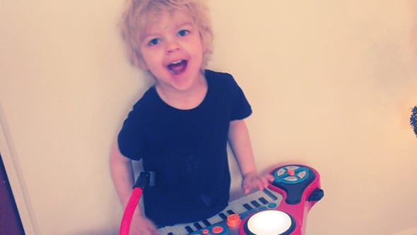 Lucien playing on his toy piano.