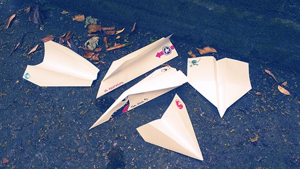 All the different paper planes we folded, lying on the ground for comparison.