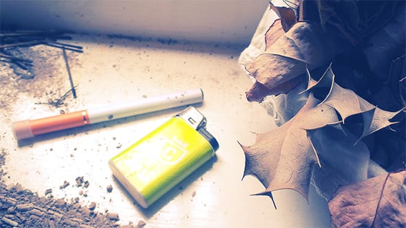 A cheap electronic cigarette lying next to a Colt lighter.