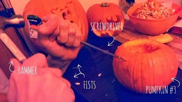 Taking a hammer, screwdriver and fists to carve the last pumpkin.