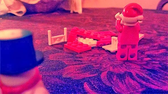 Lego santa is distraught to find his sledge destroyed by Lego Frosty the Snowman.