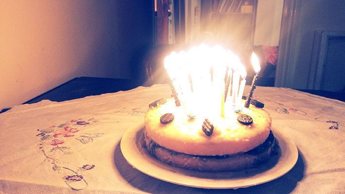A salty liquorice and lemon flavoured birthday cake with 30 individual candles on it.