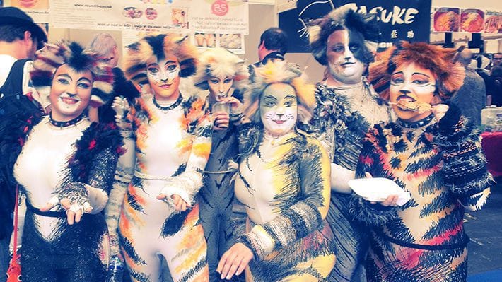 A group of people cosplaying as Cats with intricate costumes