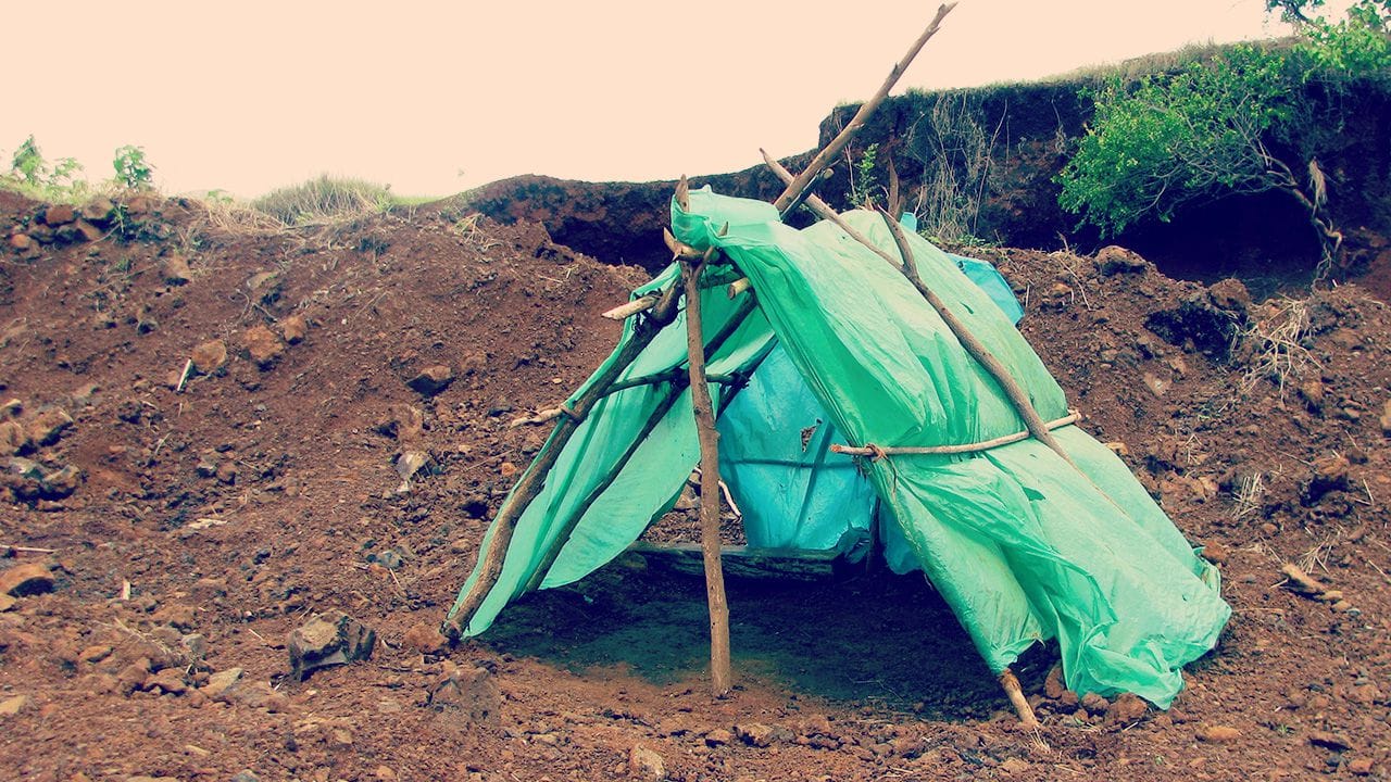 Improvised camping using sticks and plastic bags in North Madagascar.