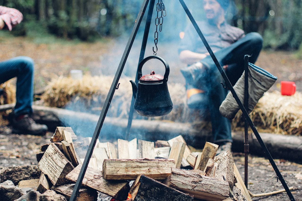 A kettle hung over the campfire.