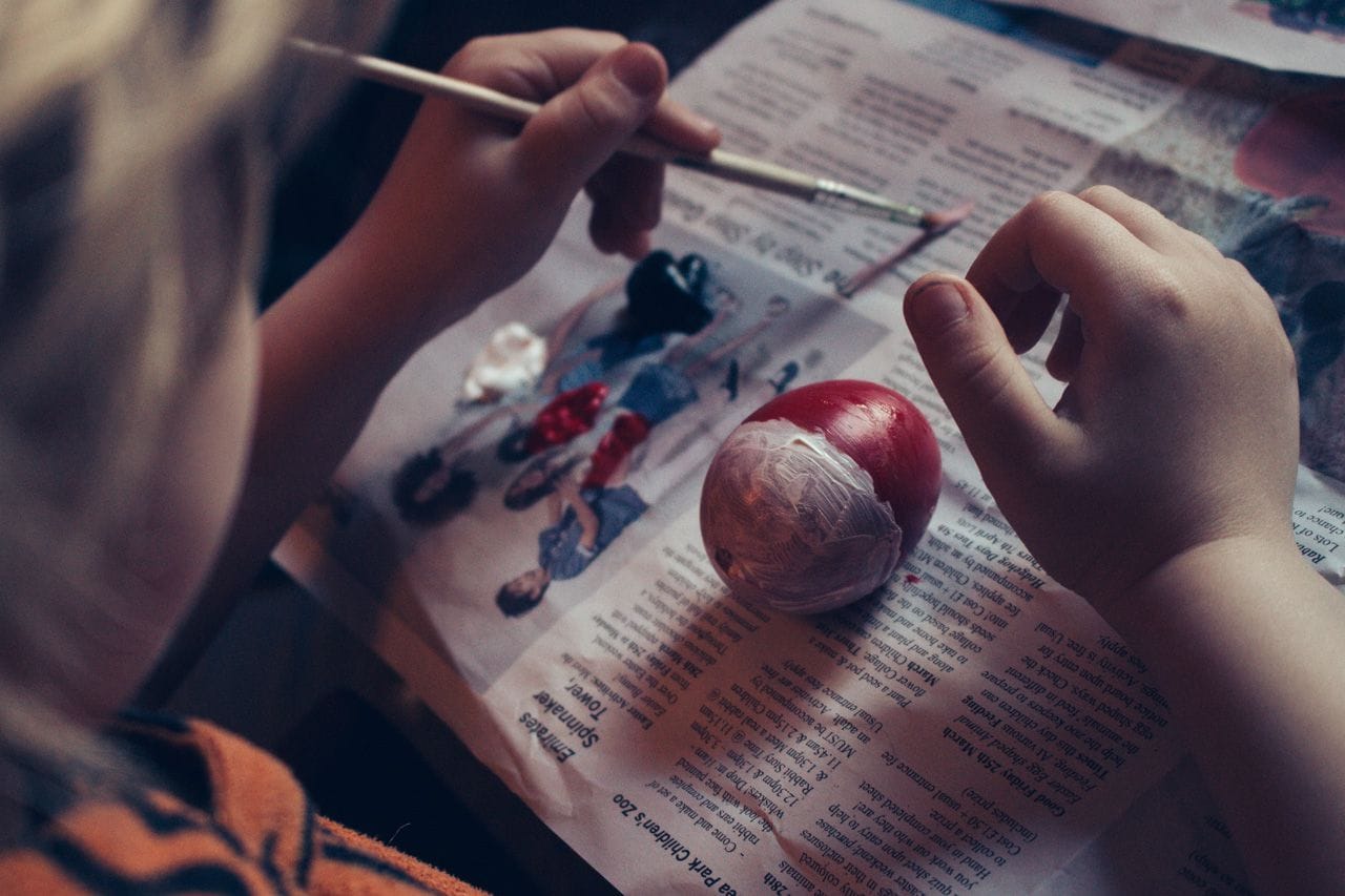 Lucien painting his Pokemon-inspired Easter egg.