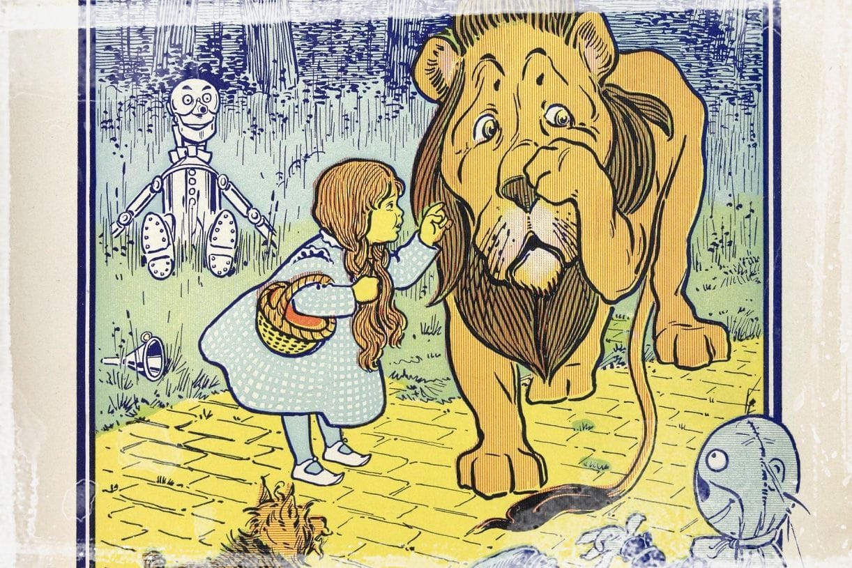 Dorothy reprimanding the cowardly lion as illustrated by W. W. Denslow.