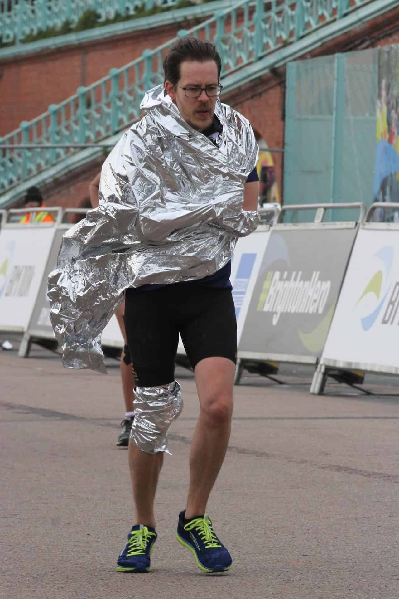 Carlos Eriksson wrapped in a silver blanket, pushing himself to finish the marathon.
