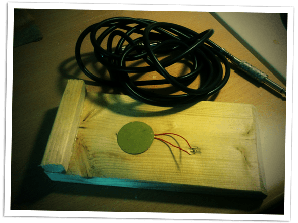 A piece of wood and some wiring to create an acoustic stomp box.