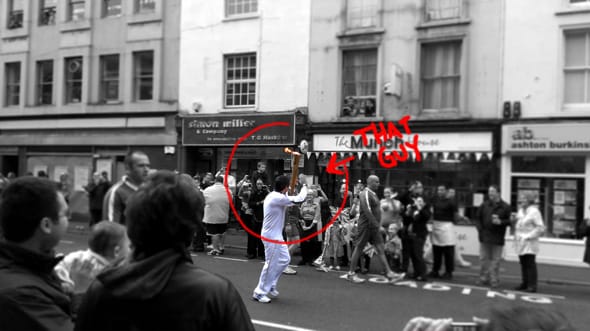 Some famous person running with the Olympic flame through Maidstone Town Centre.