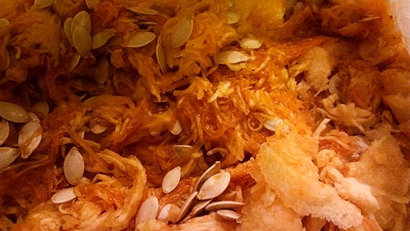 A close up of the guts and seeds of the pumpkins.
