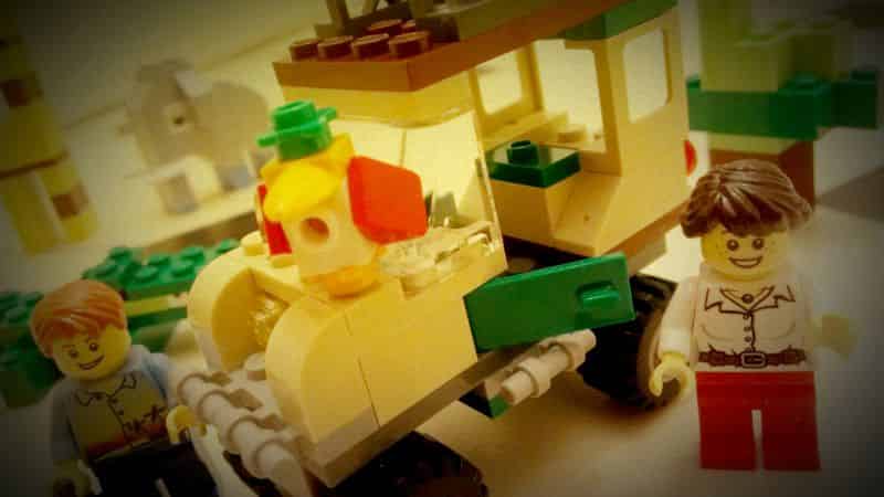 Lego minifigs and safari truck amongst Lego bricks.