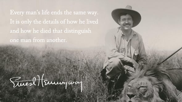 Ernest Hemingway posing with a majestic lion that he has killed for sports.