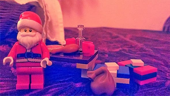 Lego santa standing by his table, well-fed and pleased.