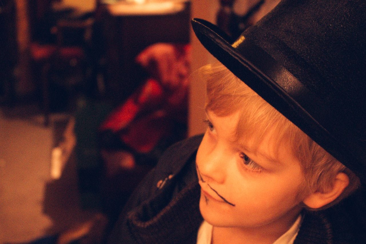 Lucien dressed as Guy Fawkes, with a top hat and a painted-on Van Dyke moustache.