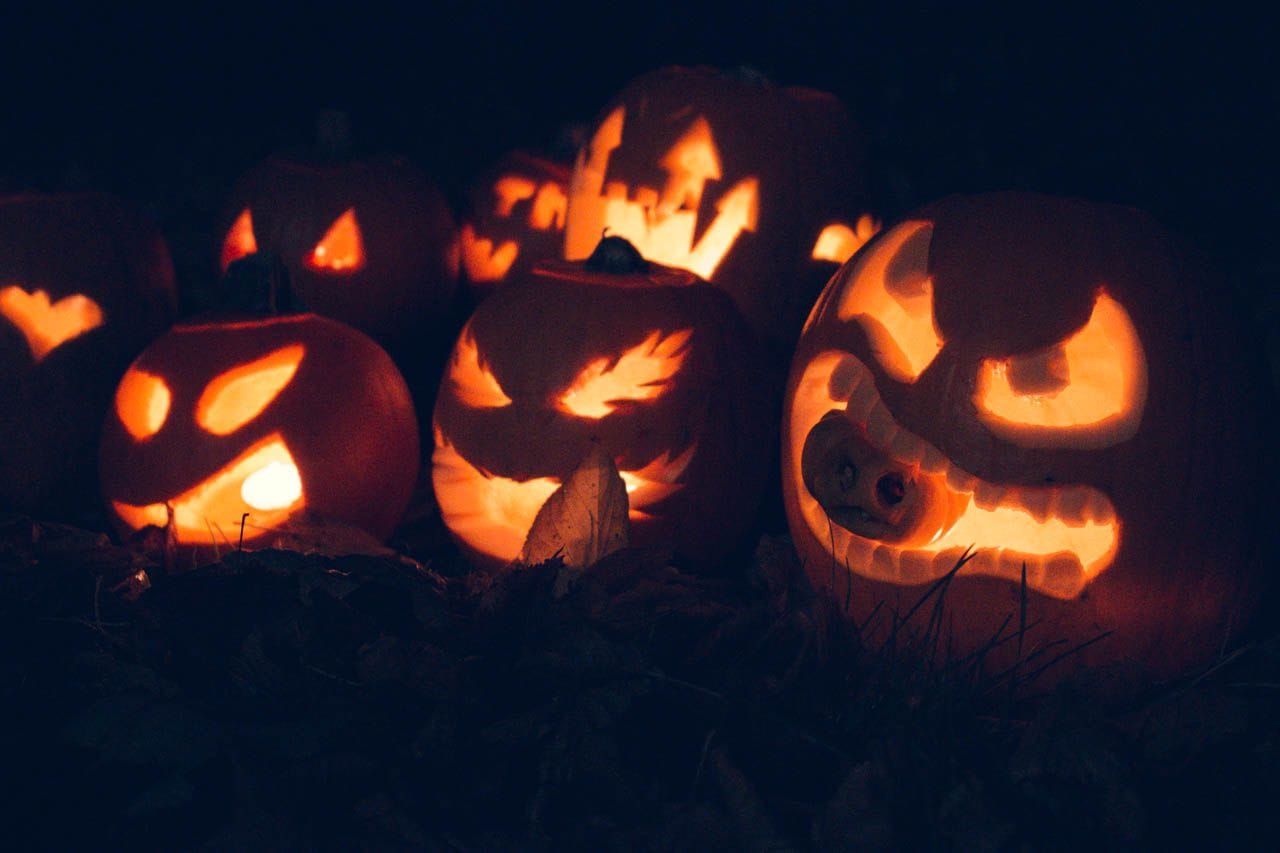 Close up of pumpkins illuminated from the candles inside them.