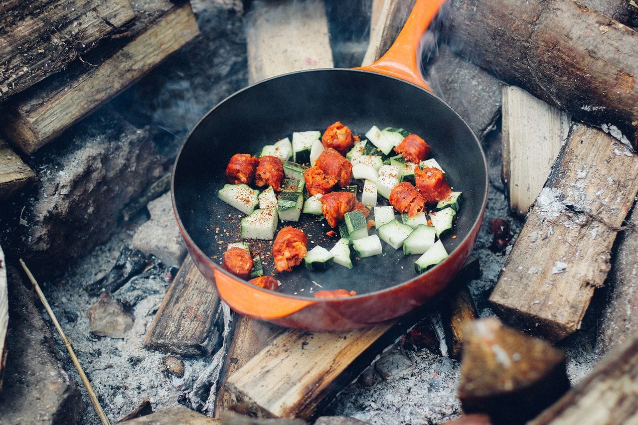 Chorizo cooking over open fire.