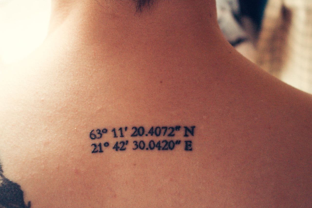 The coordinates to my childhood home tattooed between my shoulder blades.