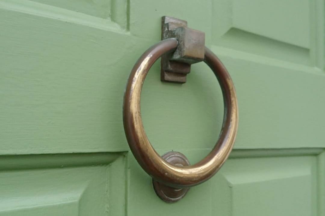 Our new green door with its aged brass door knocker.
