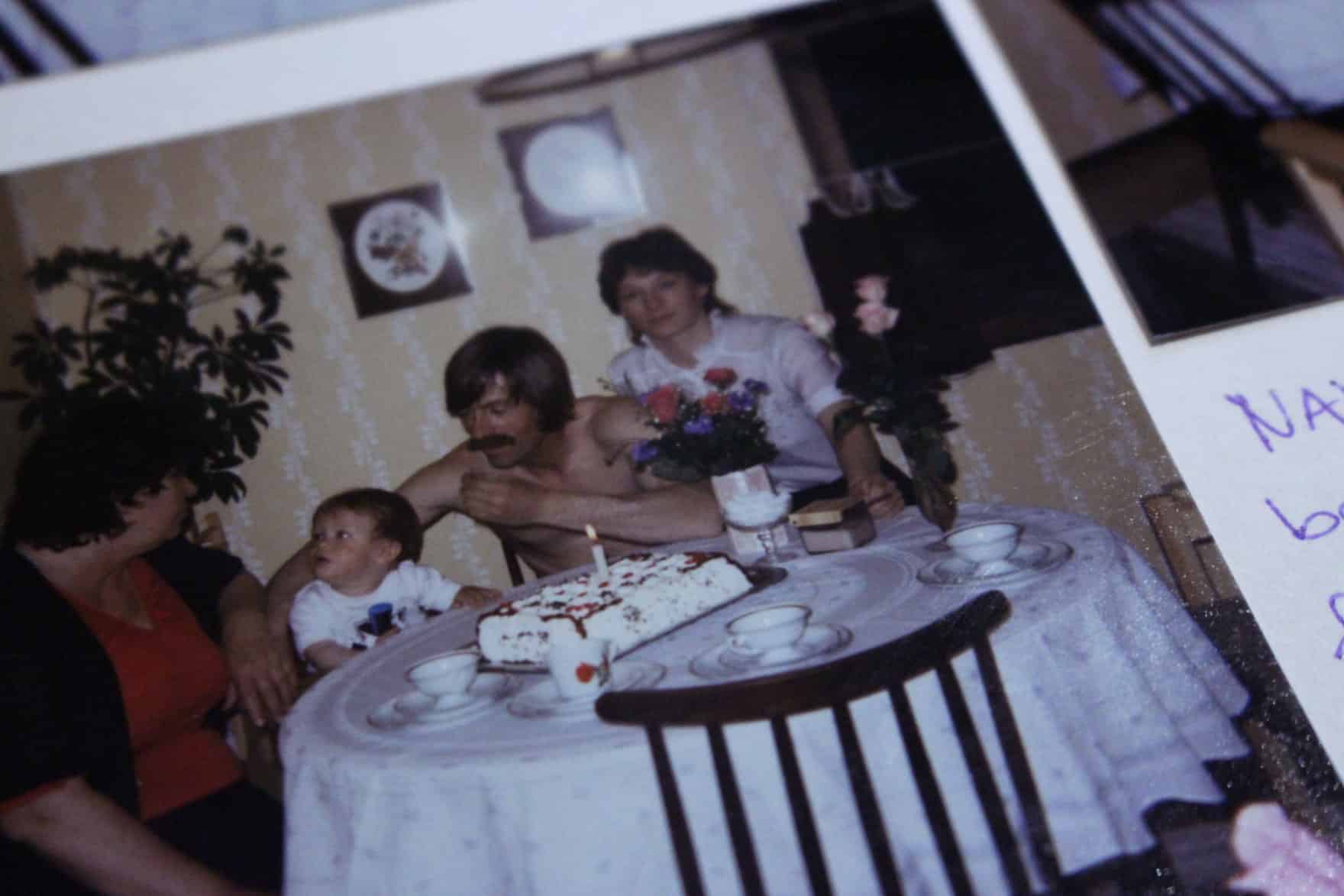 Carlos celebrating his first birthday, with his grandmother, father and aunt.