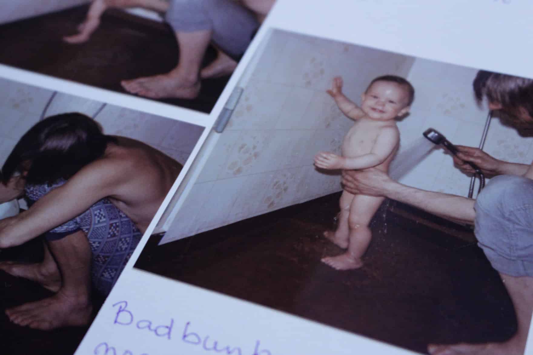 Carlos, 1-years-old, being showered by his father.