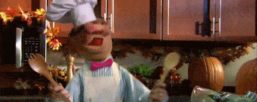 Swedish Chef from the Muppets, jumping around in his kitchen.